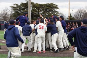 ĻӰ players and coaches celebrate a walk-off grand slam at home plate.