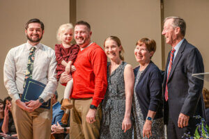 The family of Kelly McGaughey Roseberry joins ĻӰ physical therapy student Ryan McGinniss for a photo.